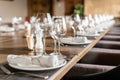 Wine glasses in the foreground. Wedding Banquet or gala dinner. The chairs and table for guests, served with cutlery and Royalty Free Stock Photo