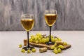 Wine glasses, fresh grapes and corks on wooden chopping board. Wine bar, winery, wine tasting concept