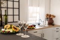 Wine glasses and fruits on kitchen counter in bright kitchen interior