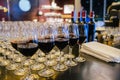 Wine glasses full of red wine and white wine poured from wine bottle by waiter at business event Royalty Free Stock Photo