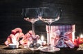 Wine glasses, gift and candles for romantic evening Royalty Free Stock Photo