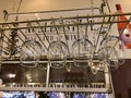 Wine glasses hang from overhead rack at Noble Estate Vineyard tasting room, Oregon