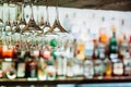 Wine glasses hanging from metal beams on defocused background. S Royalty Free Stock Photo