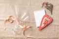 Wine glasses, hearts, blank notepad for your text on a linen tablecloth. The concept of a romantic dinner. Copy space.