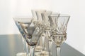 Decorative wine and martini glasses are set up in verticle rows displaying beautiful details of the glass