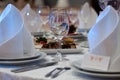 Wine glasses, napkins and salad on the table for the banquet. Royalty Free Stock Photo