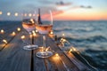 wine glasses on pier with string lights, evening mood Royalty Free Stock Photo