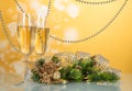 Wine glasses, pine branch, decorated with beads and ribbon, Christmas souvenir on yellow background Royalty Free Stock Photo