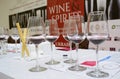 Wine glasses with red wine inside placed on a table of a tasting room, prepared for tasting