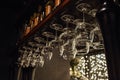 Wine glasses in shelf above a bar rack in restaurant Royalty Free Stock Photo