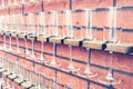 Wine glasses in shelf above a bar rack in restaurant on a vintage brick wall Royalty Free Stock Photo
