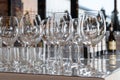 Wine glasses stand on a table in a row. Luxury catering, a beautiful room. Royalty Free Stock Photo