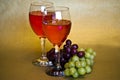 A still life of two glassea of wine and two bunches of grapes. Royalty Free Stock Photo