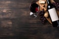 wine, grapes, and a bottle on a black wooden table, sense of luxury and sophistication. purple and green hues of the gra