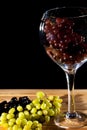 Wine grapes in glass. Green red and black grape varieties