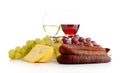 Wine and grapes isolated on white with cheese and sausage