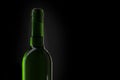 Wine green bottle silhouette. Closeup of an opening of a wine bottle with cork in front of black background with text field. There