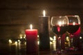 Wine in the grocery. Burning candles in the dark. The concept of Christmas and New Year comfort