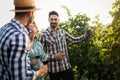 Wine grower and people in vineyard