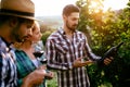 Wine growers tasting wine in vineyard Royalty Free Stock Photo