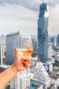 Wine in the hand hold asian women and dine in the bangkok city background