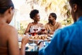 Wine, happy and friends at outdoor restaurant to relax on holiday vacation in summer together. Food, smile or black Royalty Free Stock Photo