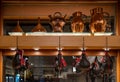 Wine and liquor store shelf with hanging Spanish wine skin boots. Typical bronze funnels and jugs for the wine