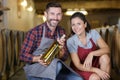 wine loving couple holding wine bottle in cellar Royalty Free Stock Photo