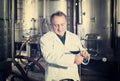 Wine maker controls quality of wine Royalty Free Stock Photo