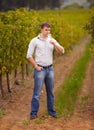 Wine maker, standing in vineyard and glass of white or man, vineyard or green grape farm and luxury, alcohol drink or Royalty Free Stock Photo