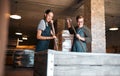 Wine making, production and cellar workers holding press tool to crush, blend and stir open tank for alcohol process