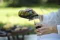 Wine pouring from bottle, outdoor picnic. concept of female alcoholism. Royalty Free Stock Photo