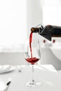 Wine. Pouring Red Wine From Bottle Into Wine Glass. Drinks. Royalty Free Stock Photo