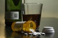 Wine and prescription pills on table, horizontal