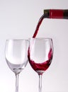 Wine puring into glasses Royalty Free Stock Photo