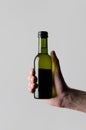 Wine Quarter / Mini Bottle Mock-Up - Male hands holding a wine bottle on a gray background