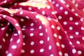 Wine red color faric with polka dots, abstract colorful background, sunlight effect Royalty Free Stock Photo