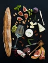 Wine and snack set. Baguette, glass of white, figs Royalty Free Stock Photo