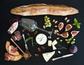 Wine and snack set. Baguette, glass of white, figs Royalty Free Stock Photo