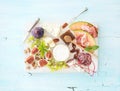 Wine snack set. Figs, grapes, nuts, cheese variety, meat appetizers and herbs