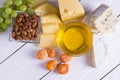 Wine with snacks - various types of cheese, figs, nuts, honey, grapes on a wooden boards background Royalty Free Stock Photo