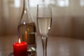 Wine sparkling white, glass and a candle on the table Royalty Free Stock Photo