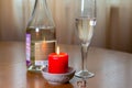 Wine sparkling white, glass and a candle on the table Royalty Free Stock Photo