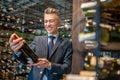 A male client choosing wina in a wine store Royalty Free Stock Photo