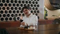 Wine taster looking glass with swirling red drink closeup. Sommelier degustation