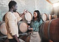 Wine tasting, couple and distillery farm worker serving red alcohol drink in glass with pipette in countryside. Happy Royalty Free Stock Photo