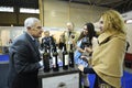 Wine tasting. Customers standing in front of a counter with glasses in hands, seller communicating