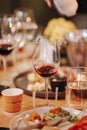 Wine tasting experience in the rustic cellar and wine bar: red wine glass and collection of excellent wines on the