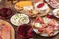 Wine tasting and pairing. A wineglass with sandwiches and a cheese platter