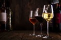 Wine tasting. White wine pouring into glass on background with selection of red, white and rose wines in glasses and bottles Royalty Free Stock Photo